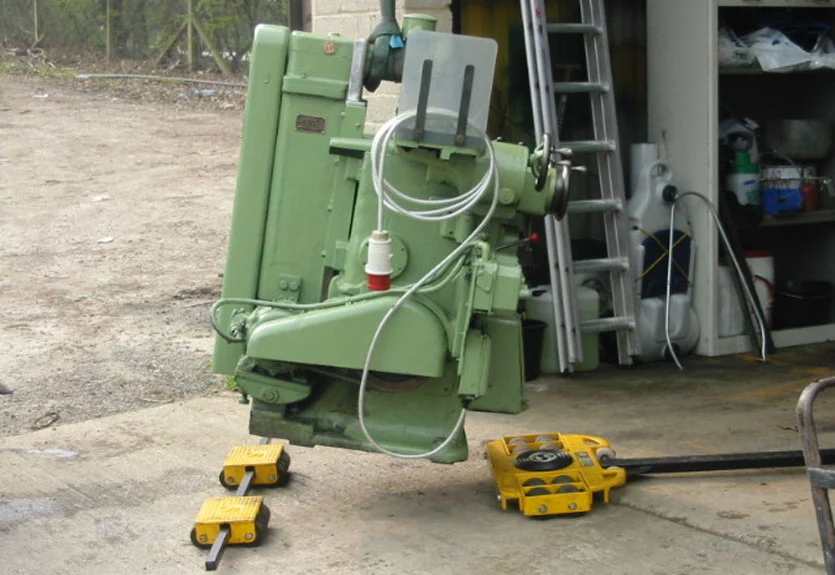 Heavy industrial machinery moving equipment showing machine skates and moving dollies