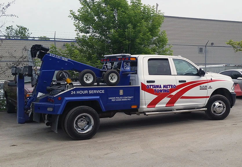 Ottawa Metro Towing truck with specialized wheel lift equipment marked for 24-hour police contract service