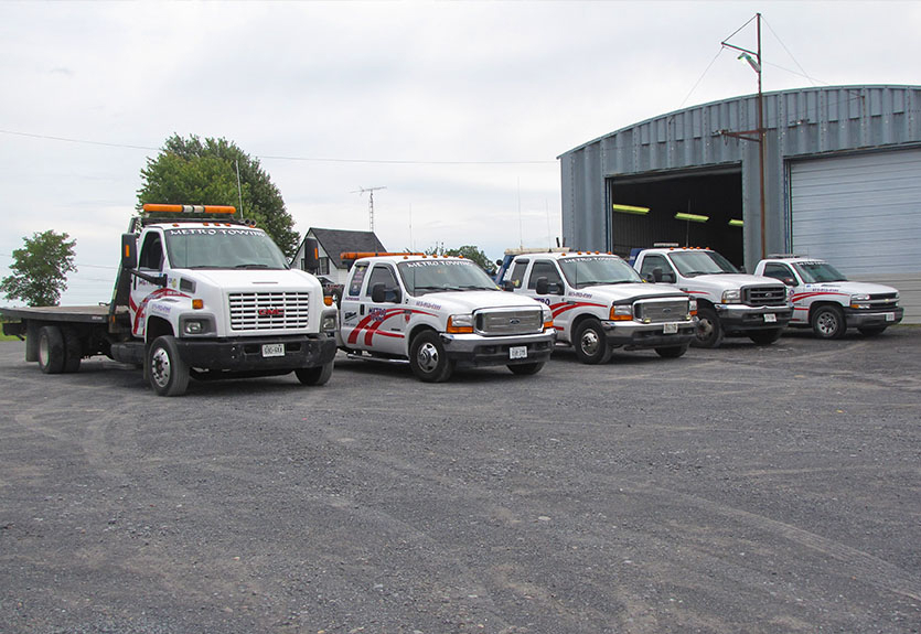 Fleet of Ottawa Metro Towing trucks lined up outside service garage